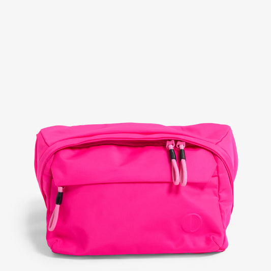 Practice Phase Sling Pack belt bag in Dragonfruit hot pink color close up front of bag