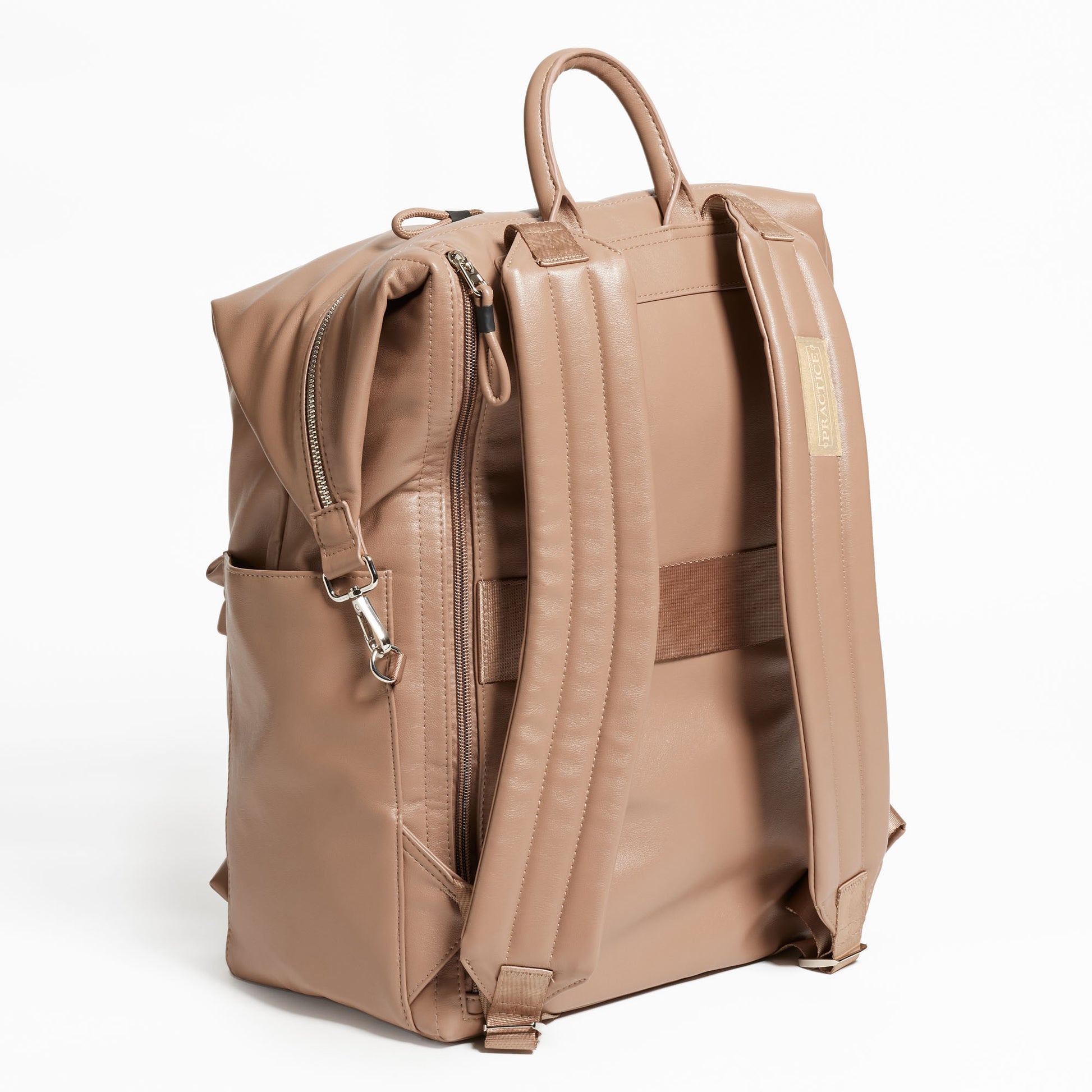 Back Facing view of the Karma Backpack in Mushroom colored Vegan Leather. Backpack has a top handle and a convertible strap to carry your backpack as a tote for easy grab and go! Back side has back zipper for easy access to your laptop, a trolley sleeve for easy travel on top of your luggage, and 2 comfy backpack shoulder straps