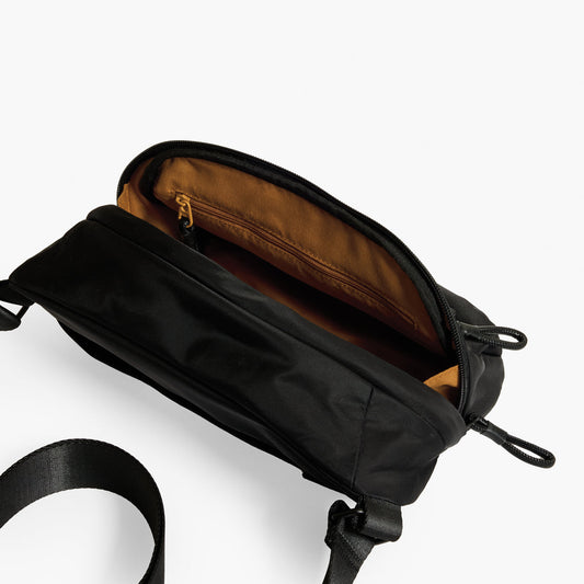 Practice Phase Sling Pack belt bag in Eclipse black color interior photo tan lining material