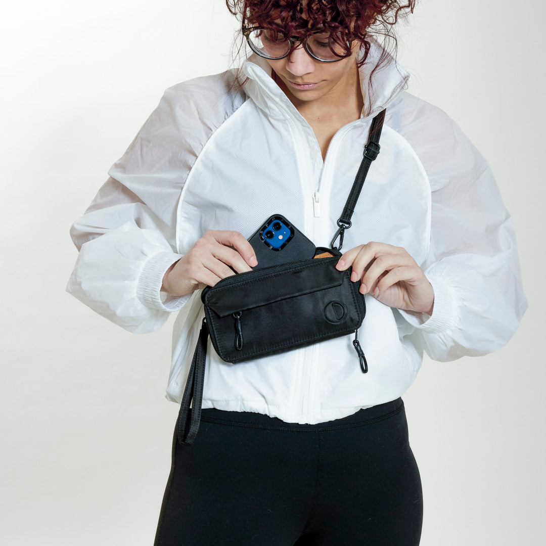 Practice Lissome Wallet Crossbody in Eclipse black color on model wearing white coat