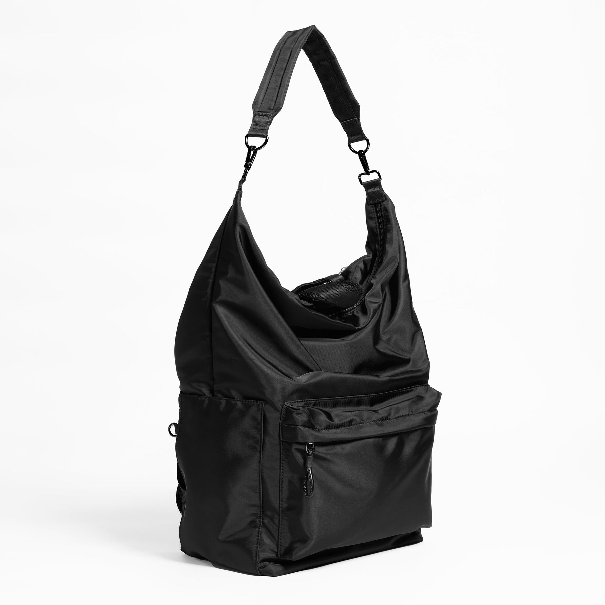 Front Facing angled view of the Karma Backpack in Black Nylon. Backpack has a top handle and a convertible strap to carry your backpack as a tote for easy grab and go!