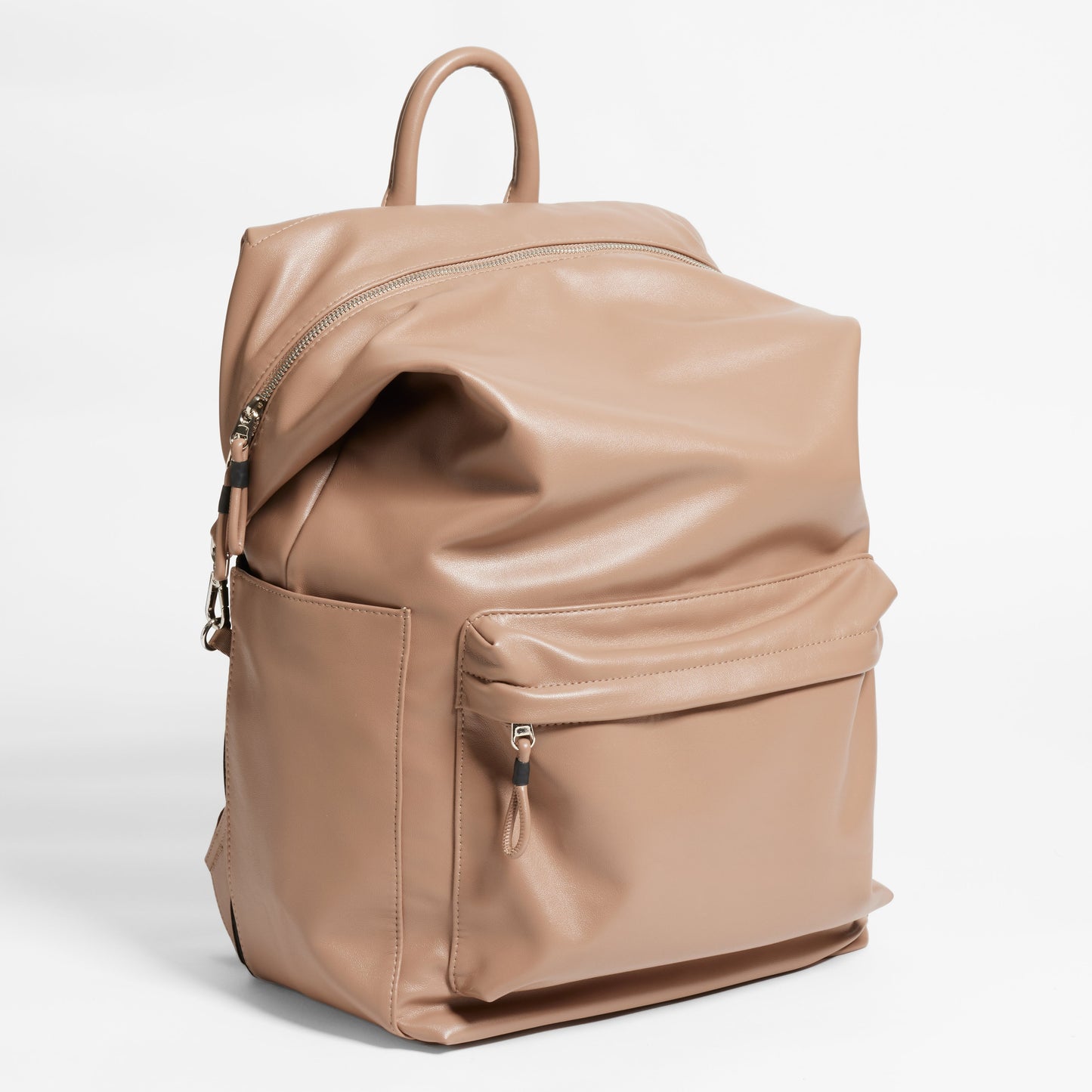 Angled Front Facing view of the Karma Backpack in Mushroom colored Vegan Leather. Backpack has a top handle and a convertible strap to carry your backpack as a tote for easy grab and go!