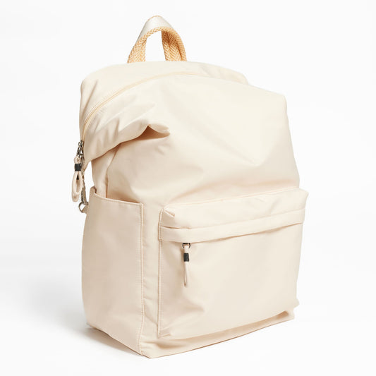 Karma Convertible Backpack in Tofu, front view of large front pocket and shoulder strap folded down
