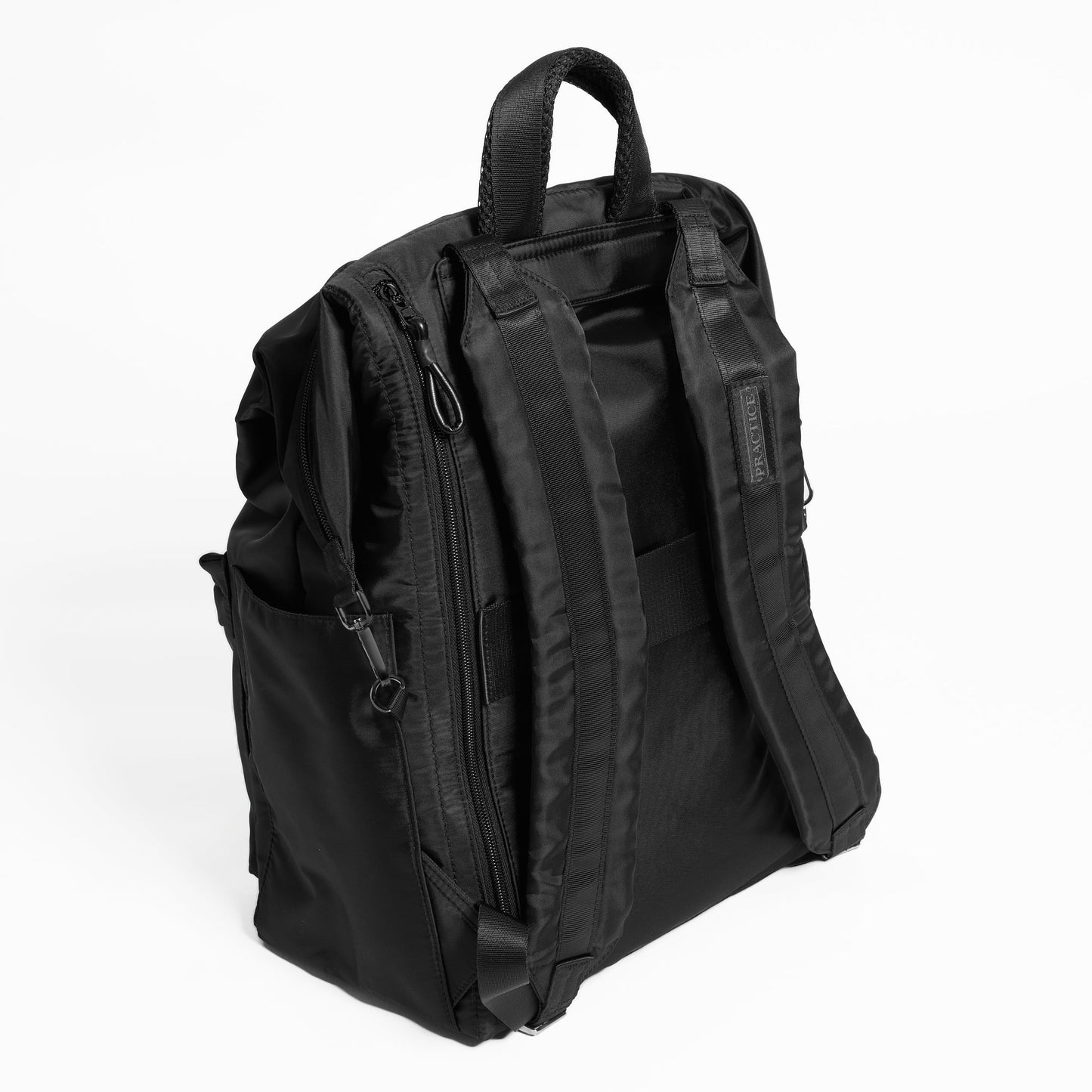 Back view of the Karma Backpack in Black Nylon. Backpack has a top handle and a convertible strap to carry your backpack as a tote for easy grab and go!